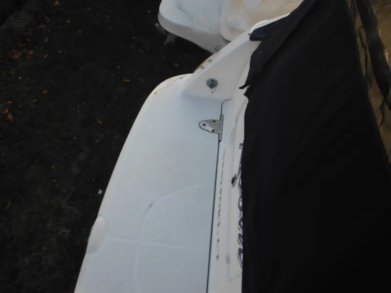 Slide: The Image of 2010 Sea Ray 260 Sundancer boat partially covered, showing deck details. - 33