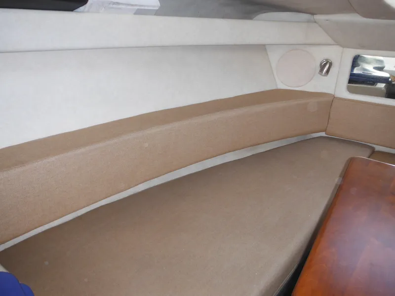 Slide: The Image of Interior cabin of 2010 Sea Ray 260 Sundancer with beige seating and wooden table. - 36