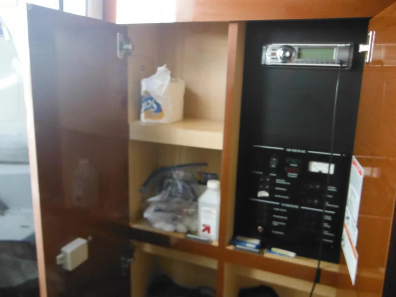 Slide: The Image of 2010 Sea Ray 260 Sundancer interior cabinet with stereo and storage shelves. - 48