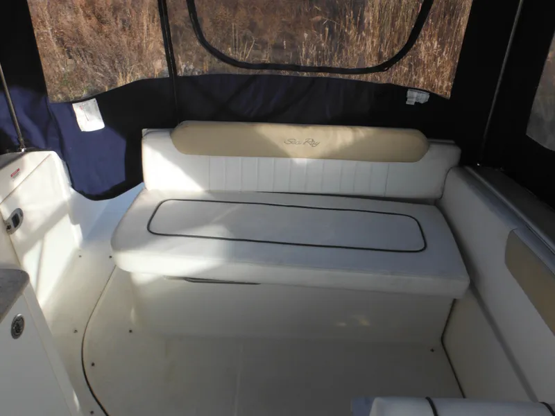 Slide: The Image of 2010 Sea Ray 260 Sundancer interior seating area with cushioned bench. - 7