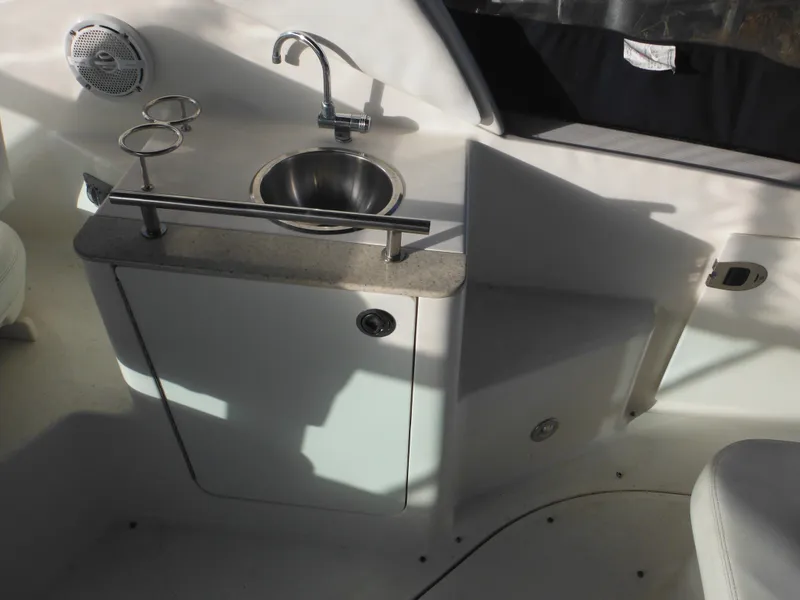 Slide: The Image of 2010 Sea Ray 260 Sundancer boat interior with sink and storage cabinet. - 9