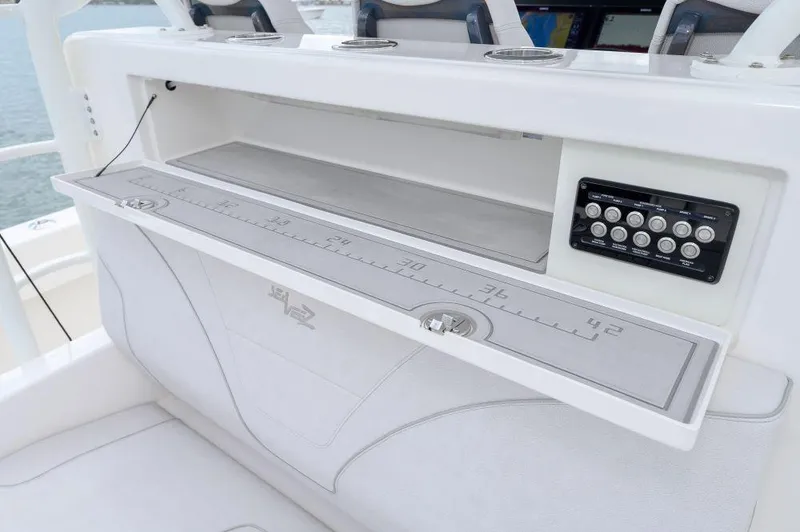 Slide: The Image of 2023 SeaVee 420Z boat console with storage and control panel. - 12