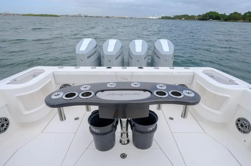 Slide: The Image of 2023 SeaVee 420Z boat with multiple outboard engines on a calm water backdrop. - 16