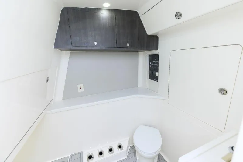 Slide: The Image of 2023 SeaVee 420Z boat interior bathroom with modern cabinetry and toilet. - 22