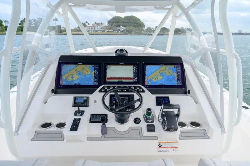 Slide: The Image of 2023 SeaVee 420Z boat dashboard with advanced navigation displays and controls. - 6