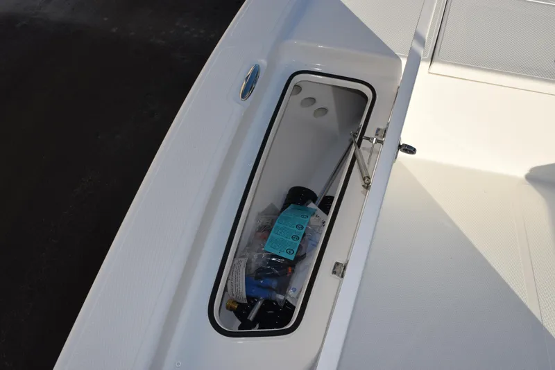 Slide: The Image of Frontier 2104 boat storage compartment, 2025 model, with various items inside. - 14