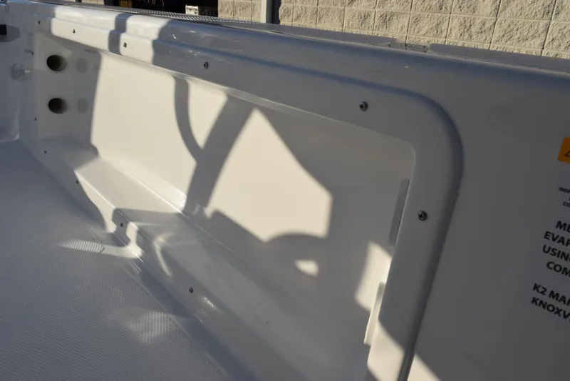 Slide: The Image of Interior view of a 2025 Frontier 2104 boat, showcasing sleek white design and shadow play. - 19