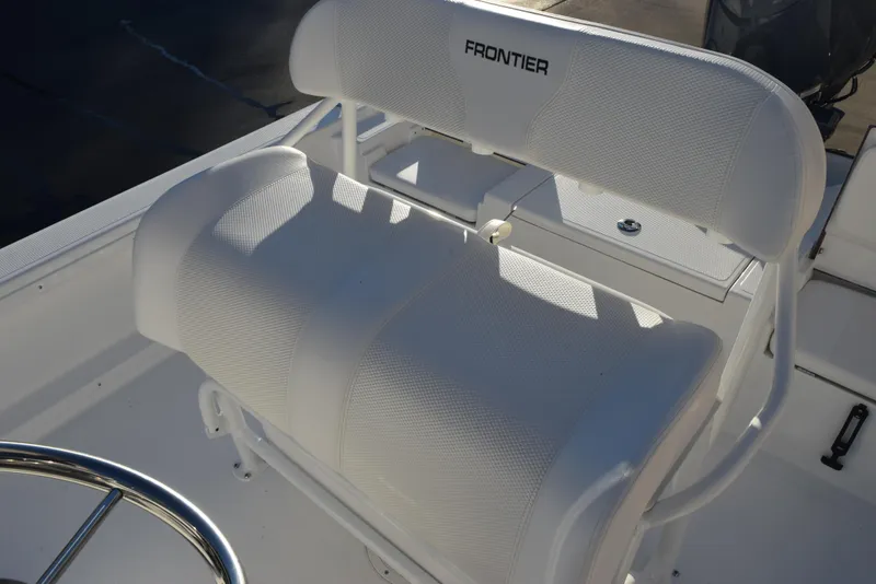Slide: The Image of 2025 Frontier 2104 boat seat with white upholstery and steering wheel. - 21