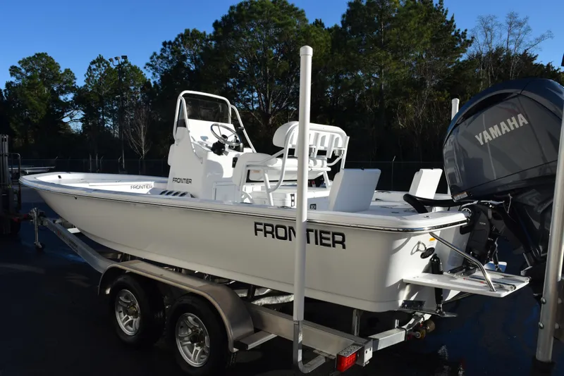 Slide: The Image of 2025 Frontier 2104 boat on trailer with Yamaha engine, parked outdoors. - 6