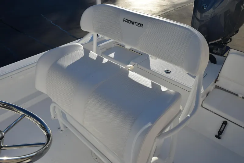 Slide: The Image of White Frontier 2104 boat seat, 2025 model, with steering wheel in sunlight. - 9