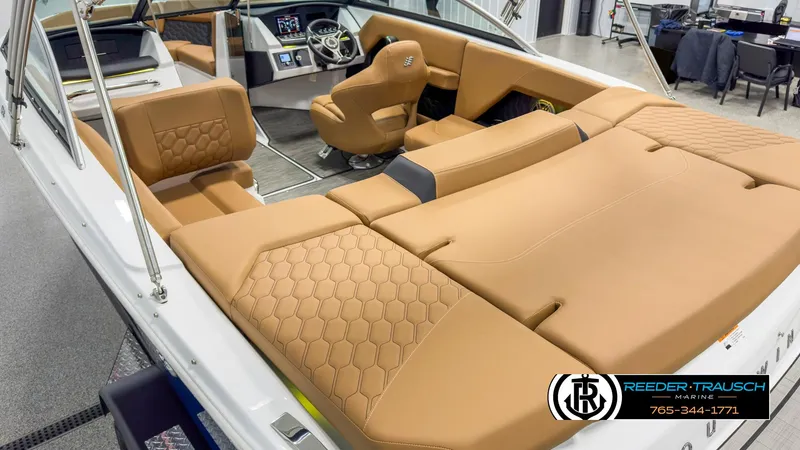 Slide: The Image of 2025 Four Winns H2 boat interior with tan leather seating and modern dashboard. - 11