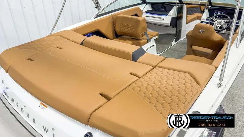 Slide: The Image of 2025 Four Winns H2 boat interior with tan leather seating and modern design. - 12