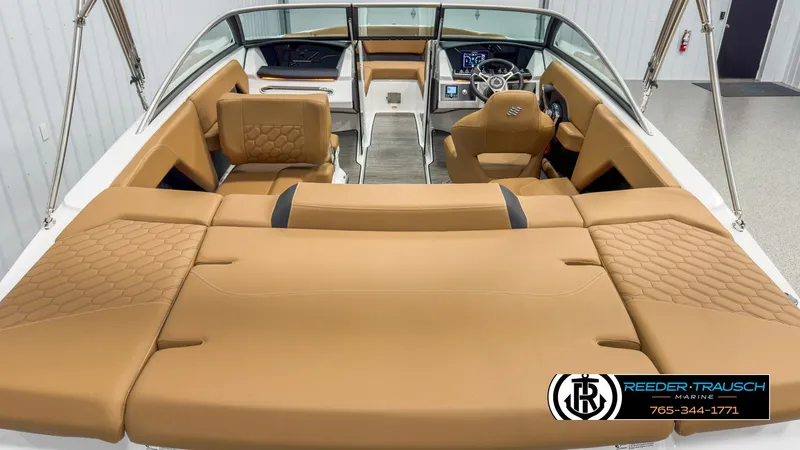 Slide: The Image of 2025 Four Winns H2 boat interior with tan seating and modern dashboard. - 13