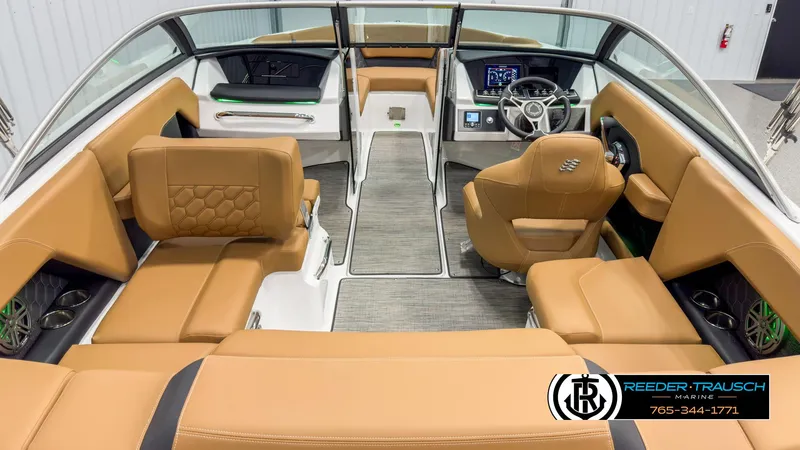 Slide: The Image of 2025 Four Winns H2 boat interior with tan leather seating and modern dashboard. - 14