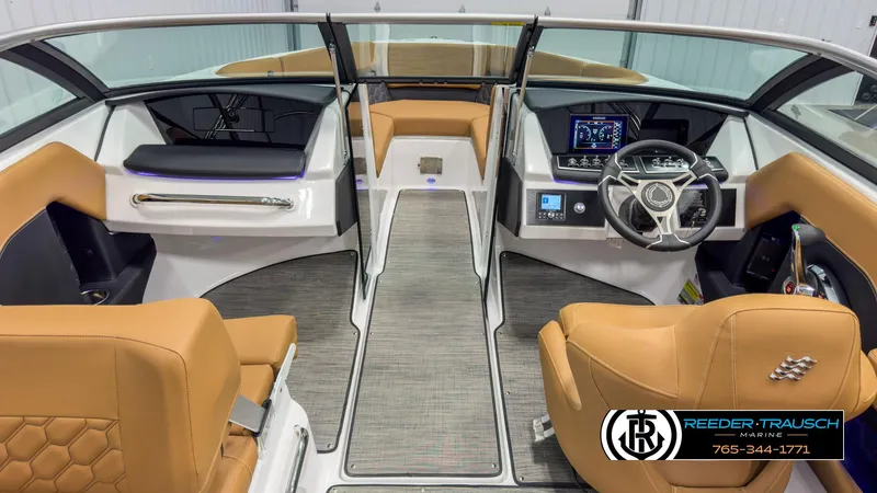 Slide: The Image of 2025 Four Winns H2 boat interior with tan seats, modern dashboard, and steering wheel. - 15