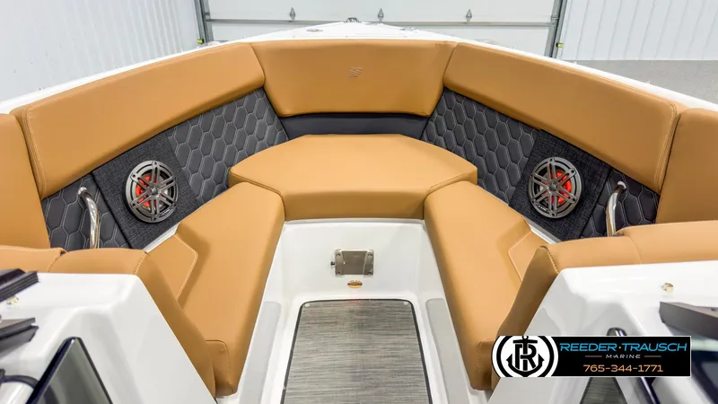 Slide: The Image of 2025 Four Winns H2 boat interior with tan seating and hexagonal speaker design. - 16