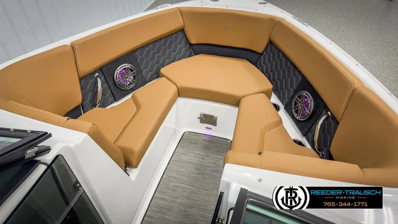 Slide: The Image of 2025 Four Winns H2 boat interior with tan seating and modern audio system. - 20