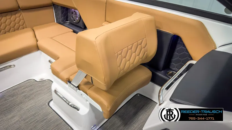 Slide: The Image of 2025 Four Winns H2 boat interior with tan leather seating and hexagonal stitching design. - 23