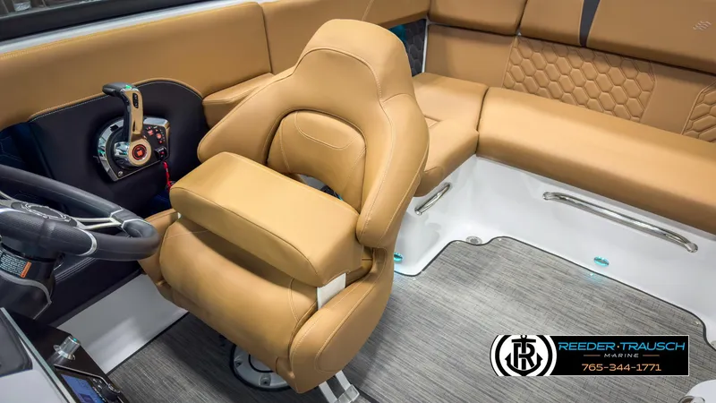 Slide: The Image of 2025 Four Winns H2 boat interior with tan seating and modern controls. - 25