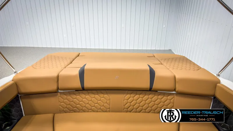 Slide: The Image of 2025 Four Winns H2 boat interior with tan cushioned seating and hexagonal pattern design. - 26