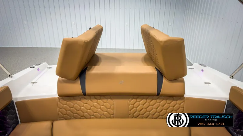 Slide: The Image of 2025 Four Winns H2 boat interior with tan leather seating and hexagonal stitching. - 27