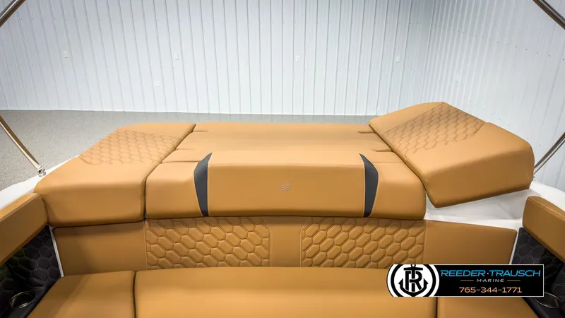 Slide: The Image of 2025 Four Winns H2 boat interior with tan upholstery and hexagonal stitching design. - 29