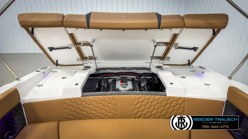 Slide: The Image of 2025 Four Winns H2 boat engine compartment with open hatch and tan seating. - 30