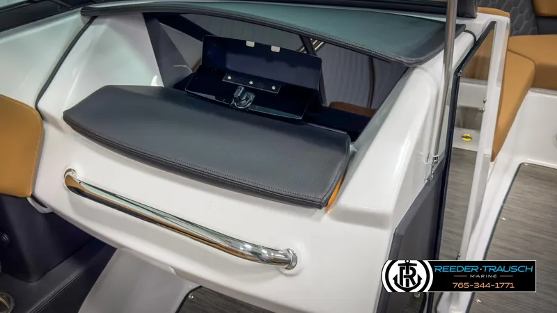 Slide: The Image of 2025 Four Winns H2 boat interior with open storage compartment and sleek design. - 32