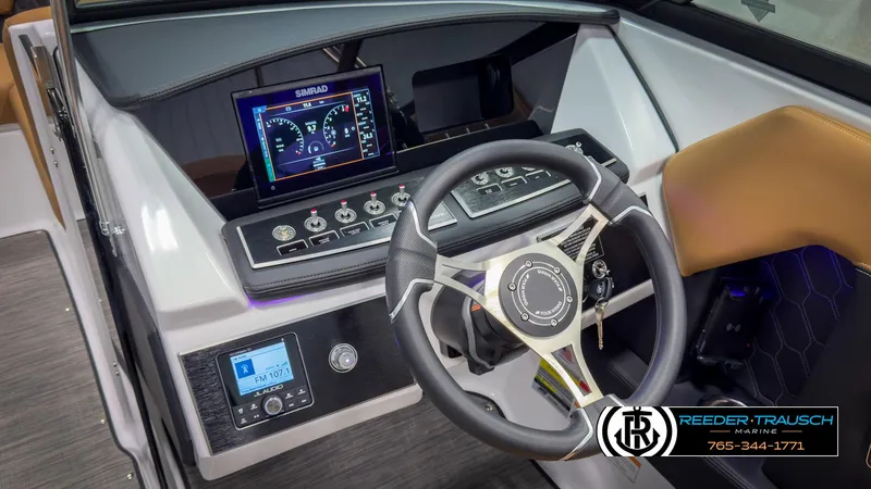 Slide: The Image of 2025 Four Winns H2 boat dashboard with steering wheel and digital display. - 34