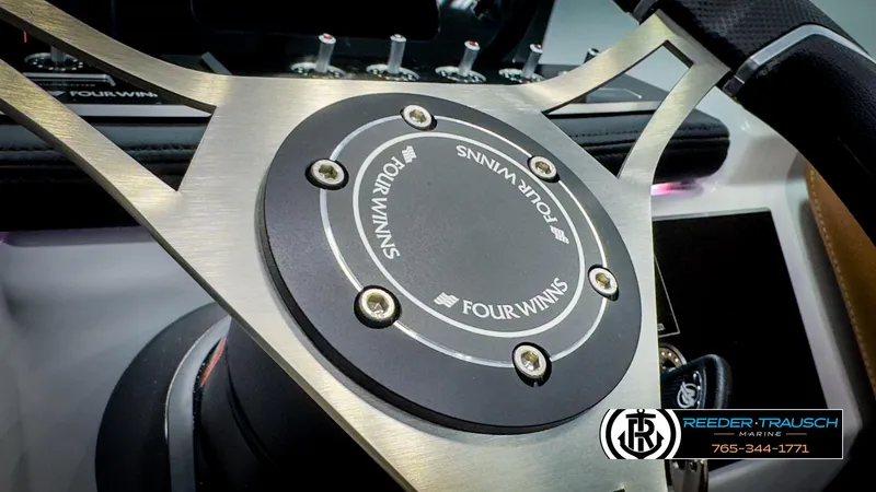 Slide: The Image of Steering wheel of 2025 Four Winns H2 boat, featuring sleek metallic design. - 35
