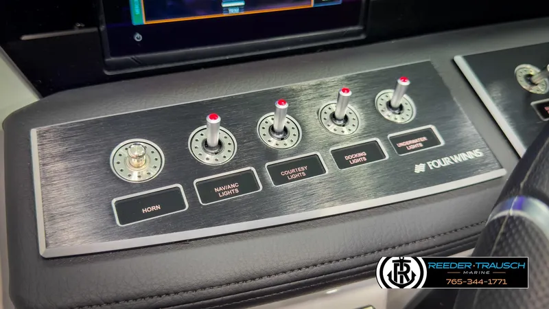 Slide: The Image of Control panel of 2025 Four Winns H2 boat with labeled switches for lights and horn. - 38