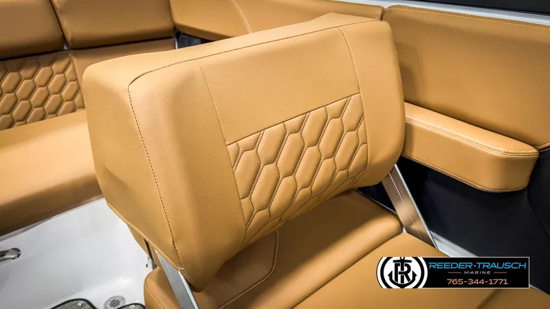 Slide: The Image of 2025 Four Winns H2 boat interior with tan leather seats and hexagonal stitching. - 43