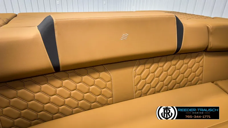 Slide: The Image of 2025 Four Winns H2 boat interior with tan leather seats and hexagonal stitching. - 44