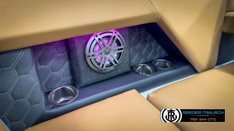Slide: The Image of 2025 Four Winns H2 boat interior with speaker, cup holders, and stylish upholstery. - 48