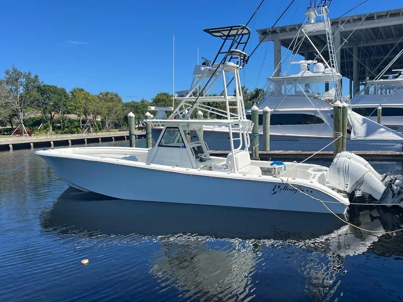The Image of 2017 Yellowfin 39 boat docked in marina under clear blue sky. - 1