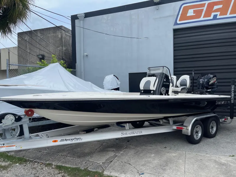 The Image of 2024 ShearWater X22 boat on trailer outside garage. - 1