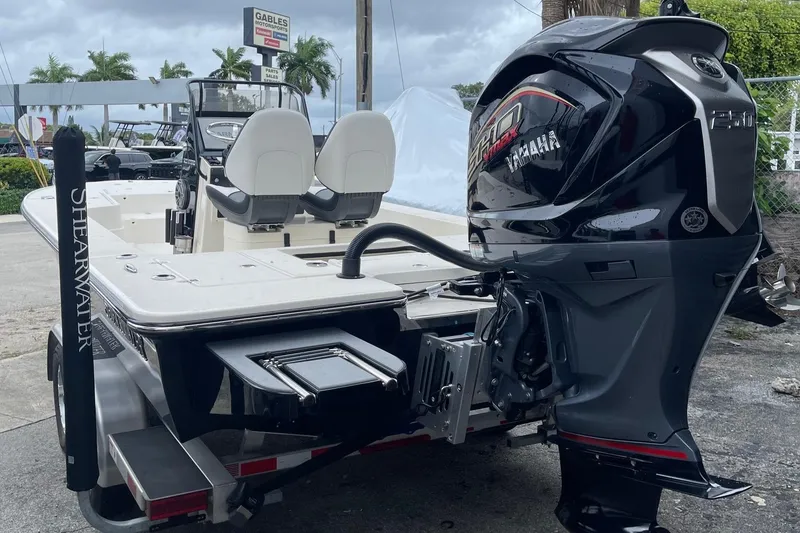 Slide: The Image of 2024 ShearWater X22 boat with Yamaha outboard motor, parked outdoors. - 3