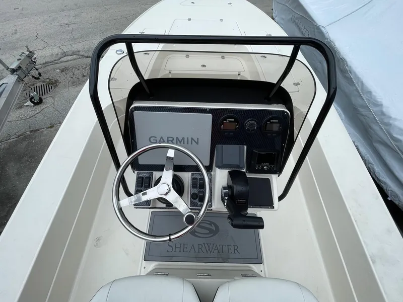 Slide: The Image of 2024 ShearWater X22 boat console with Garmin navigation system and steering wheel. - 5