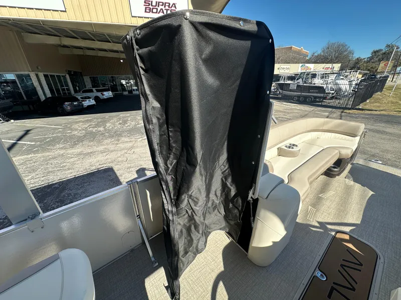 Slide: The Image of 2025 Avalon Catalina Cruise Funship interior with seating and privacy curtain. - 13