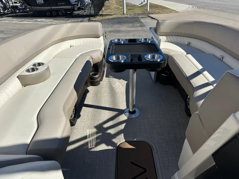 Slide: The Image of 2025 Avalon Catalina Cruise Funship interior with beige seating and central table. - 14