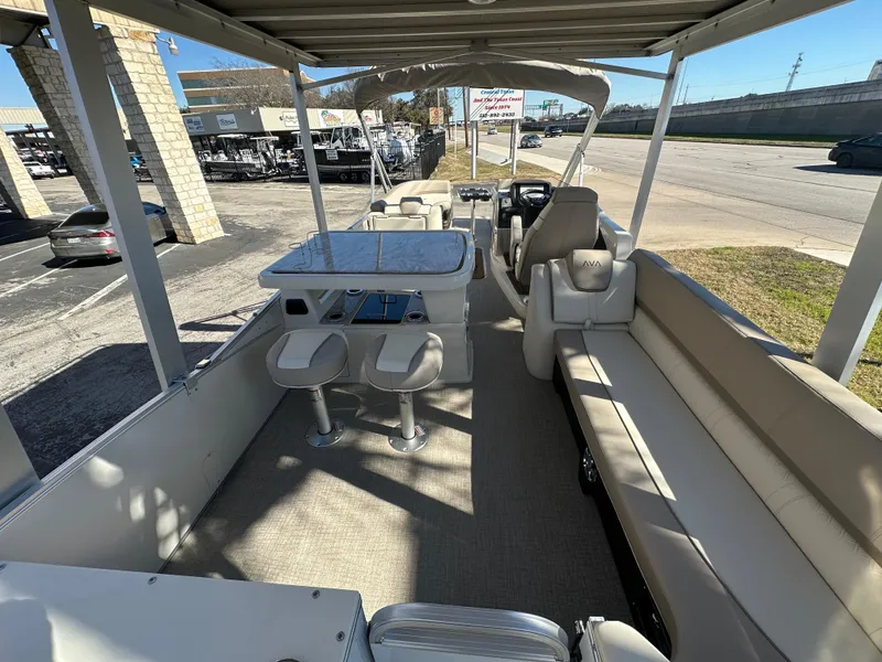 Slide: The Image of 2025 Avalon Catalina Cruise Funship 27' interior with seating and table, parked outdoors. - 21