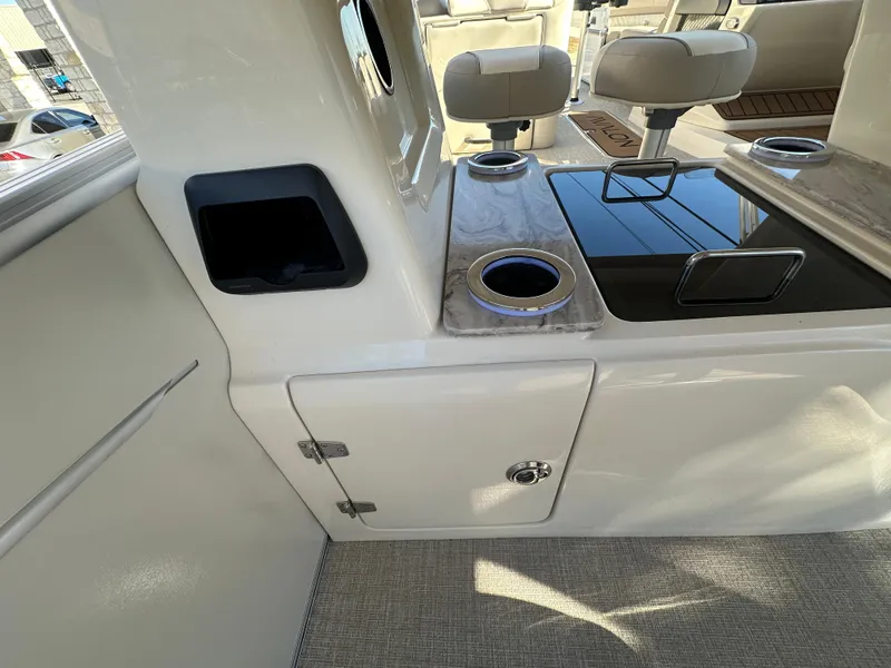 Slide: The Image of Interior of 2025 Avalon Catalina Cruise Funship, featuring seating and cup holders. - 26