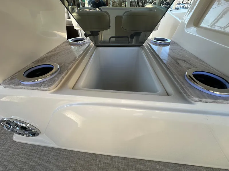 Slide: The Image of 2025 Avalon Catalina Cruise Funship interior with cup holders and storage compartment. - 27
