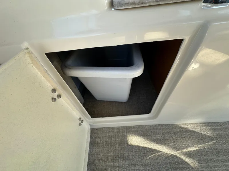 Slide: The Image of Storage compartment with a bin on the 2025 Avalon Catalina Cruise Funship boat. - 28