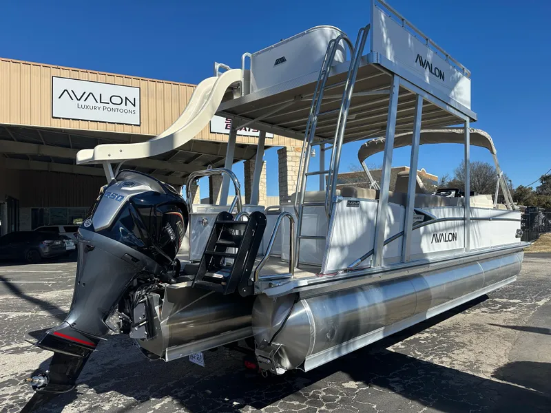 Slide: The Image of 2025 Avalon Catalina Cruise Funship pontoon boat with slide, parked outside Avalon dealership. - 3