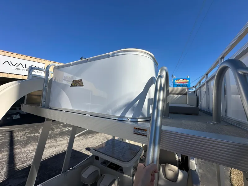 Slide: The Image of 2025 Avalon Catalina Cruise Funship boat with upper deck, showcased at a dealership. - 39