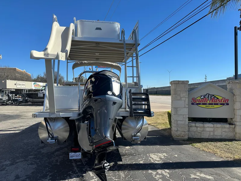 Slide: The Image of 2025 Avalon Catalina Cruise Funship 27' with slide and outboard motor, parked outdoors. - 4