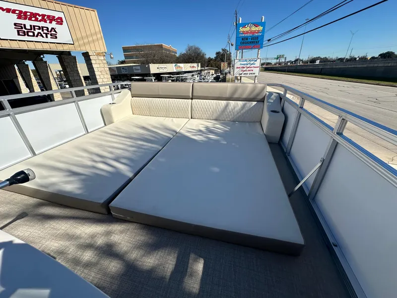 Slide: The Image of 2025 Avalon Catalina Cruise Funship 27' with spacious sun deck, displayed at a boat dealership. - 42