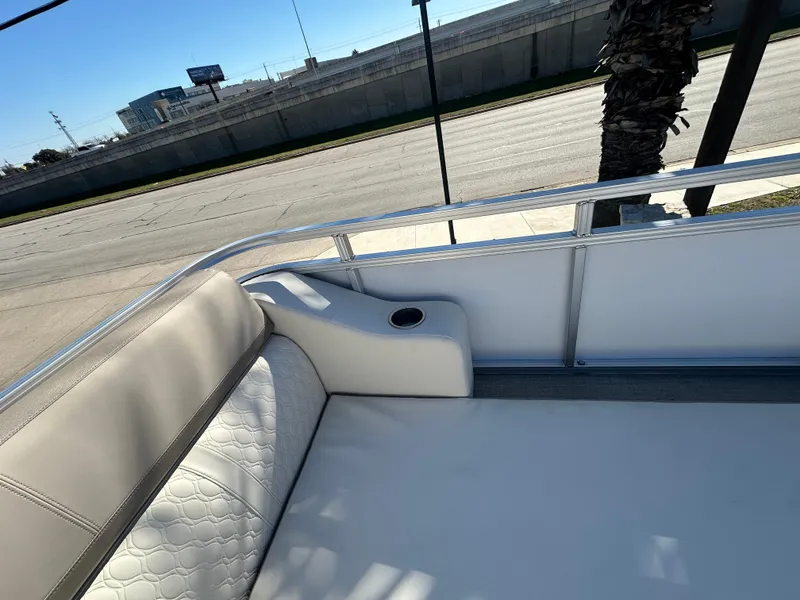 Slide: The Image of 2025 Avalon Catalina Cruise Funship interior with cushioned seating and cup holder. - 43