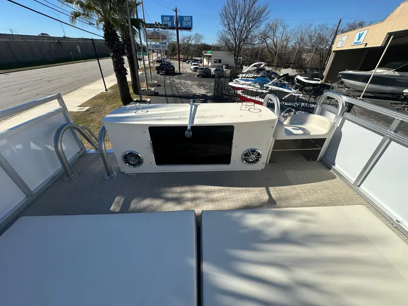 Slide: The Image of 2025 Avalon Catalina Cruise Funship boat deck with seating and speakers, parked near a street. - 45